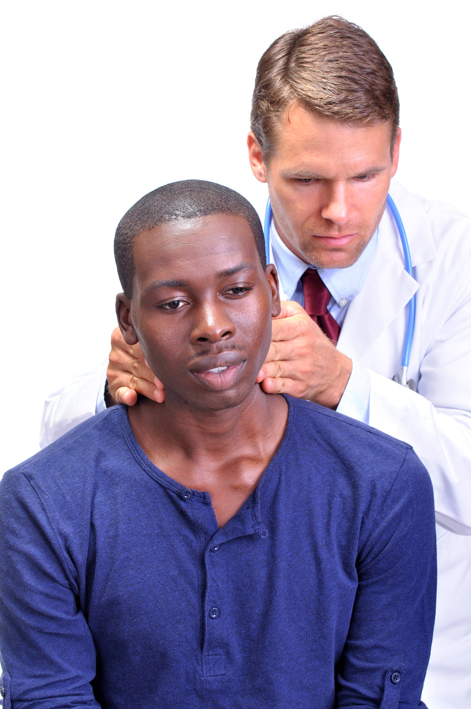 Young man receives medical examination by doctor who feels the neck checking for enlarged lymph nodes