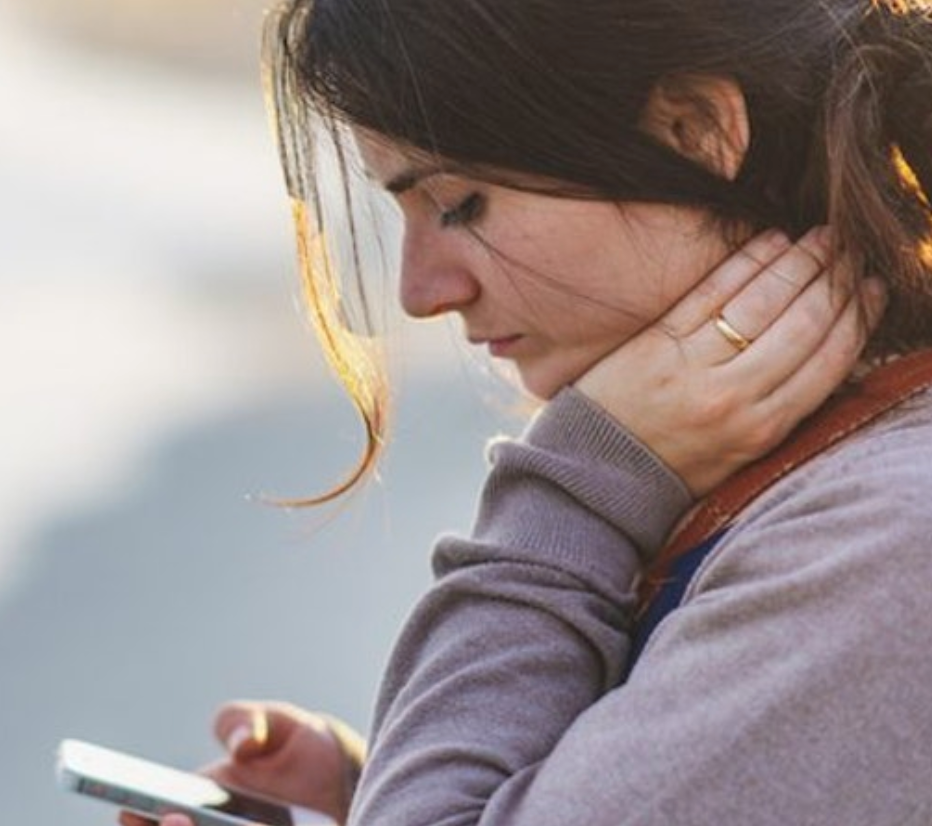 People looking down on phone causing forward head posture syndrome.