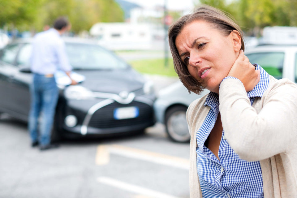 Woman feeling pain after car accident in the city